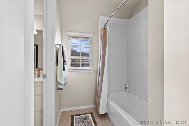 bathroom with shower / bath combination with curtain and tile patterned floors