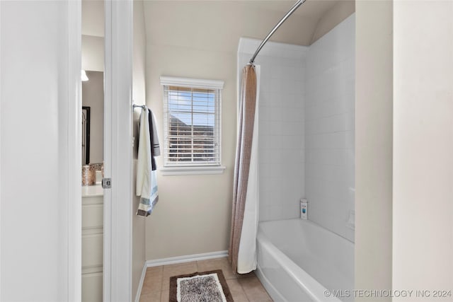 bathroom featuring tile patterned flooring and shower / tub combo with curtain