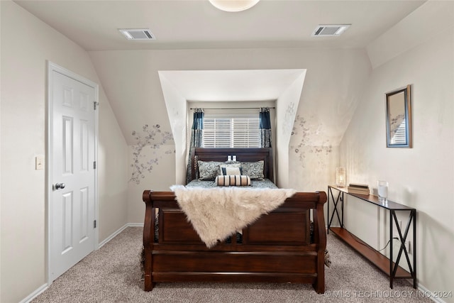 bedroom featuring lofted ceiling and light colored carpet