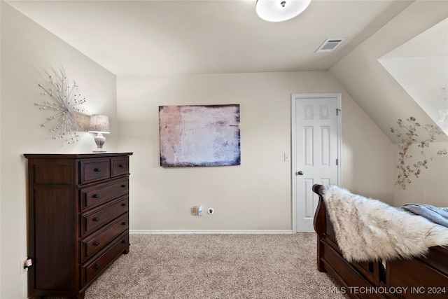 carpeted bedroom featuring lofted ceiling