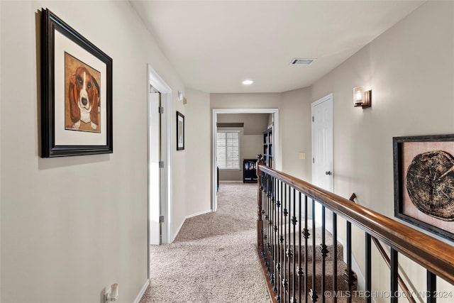 hall featuring light colored carpet