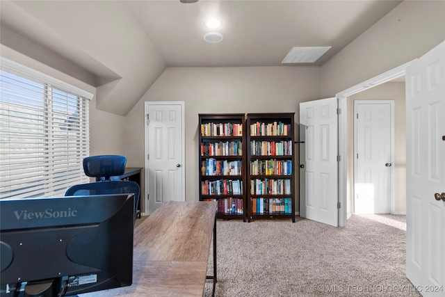 carpeted office featuring vaulted ceiling