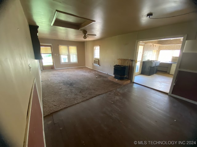 unfurnished room with cooling unit, wood-type flooring, and ceiling fan