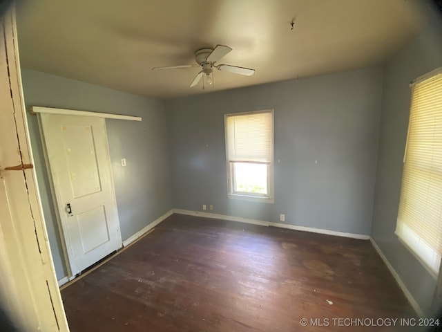 spare room featuring ceiling fan and dark hardwood / wood-style flooring