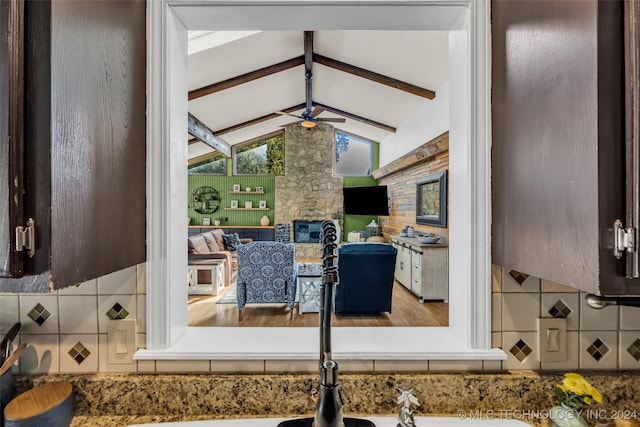 interior space featuring a stone fireplace and ceiling fan