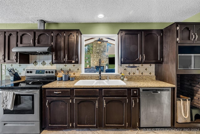 kitchen with tasteful backsplash, appliances with stainless steel finishes, sink, and dark brown cabinets