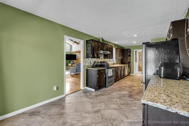 kitchen featuring sink, a textured ceiling, dark brown cabinets, electric range, and ceiling fan