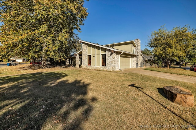 view of home's exterior with a garage and a yard