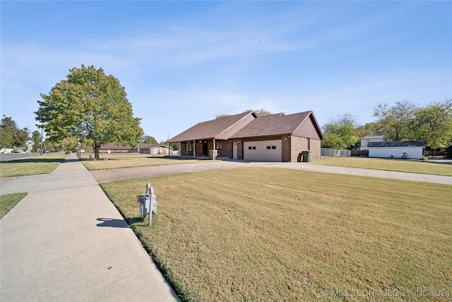 view of front of property with a front lawn and a garage