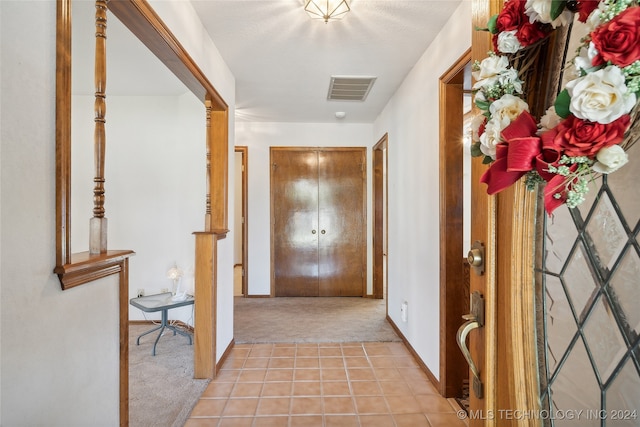 hallway featuring light carpet