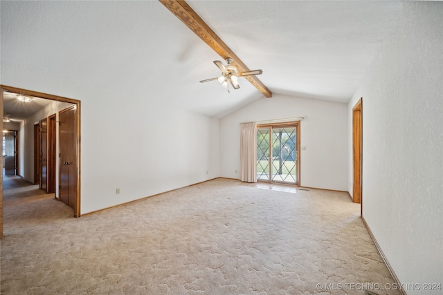 unfurnished living room featuring ceiling fan, carpet floors, and vaulted ceiling with beams