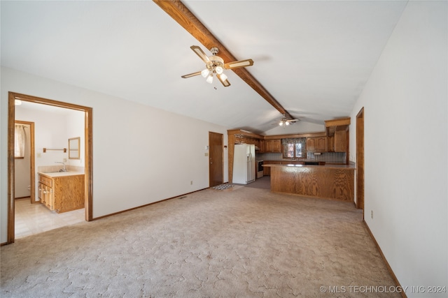 unfurnished living room with lofted ceiling with beams, light colored carpet, and ceiling fan