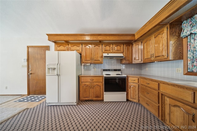 kitchen with white appliances and tasteful backsplash