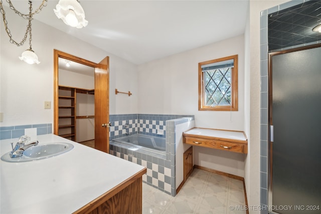 bathroom with vanity and shower with separate bathtub