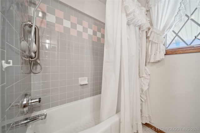 bathroom with shower / bath combo with shower curtain