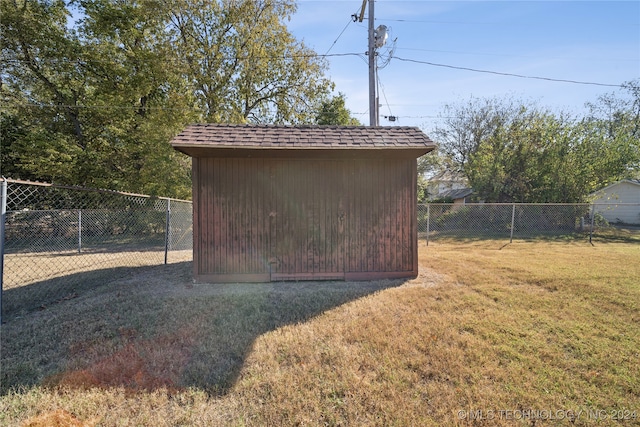 view of outbuilding featuring a lawn