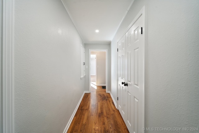 hallway featuring ornamental molding and dark hardwood / wood-style floors