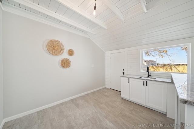 interior space featuring wood ceiling, lofted ceiling with beams, and sink