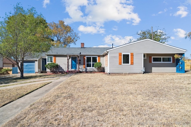 ranch-style house featuring a front lawn and a garage