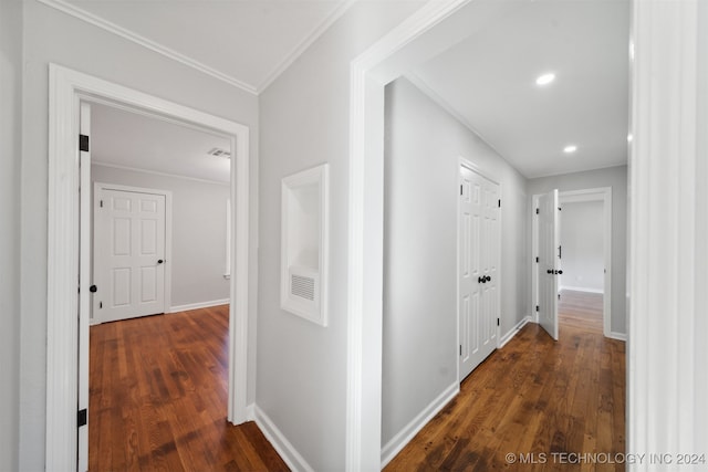 corridor featuring crown molding and dark hardwood / wood-style floors