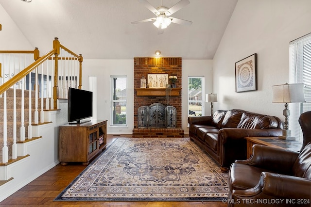 living room with vaulted ceiling, dark hardwood / wood-style floors, a brick fireplace, plenty of natural light, and ceiling fan