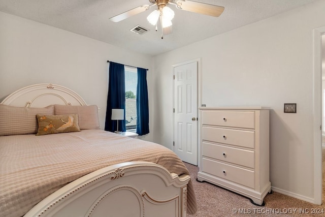 bedroom featuring ceiling fan and light colored carpet