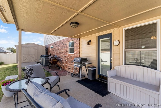 view of patio with a shed and grilling area