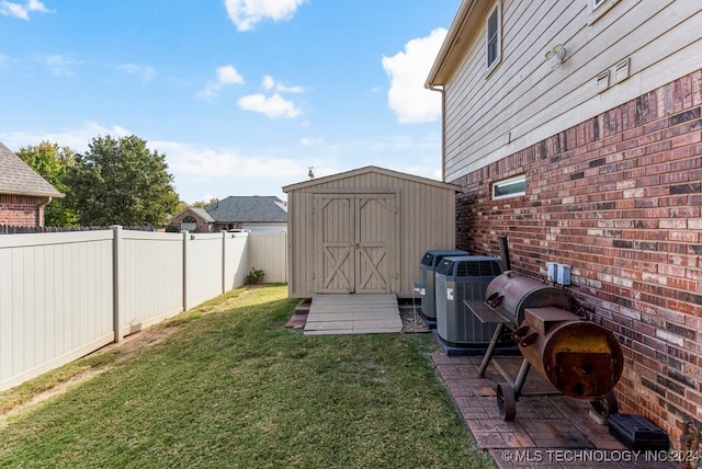 view of yard with a storage unit and central AC unit