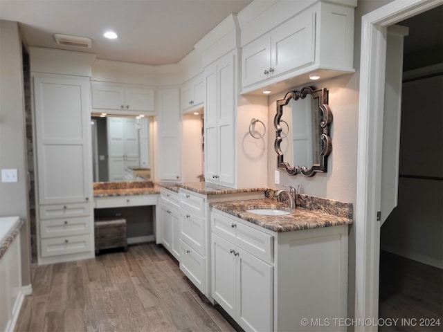 bathroom with vanity and hardwood / wood-style floors