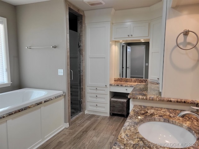 bathroom featuring vanity, hardwood / wood-style floors, and separate shower and tub