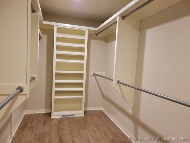 spacious closet featuring light hardwood / wood-style floors