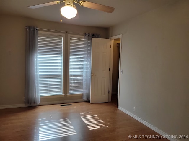 empty room featuring ceiling fan and light wood-type flooring