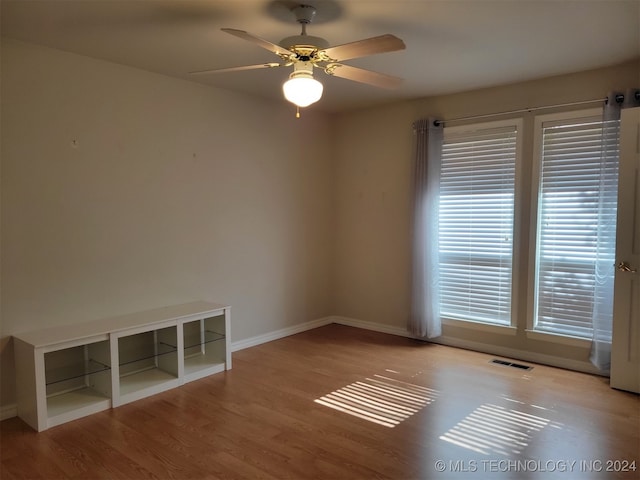 spare room featuring light wood-type flooring and ceiling fan