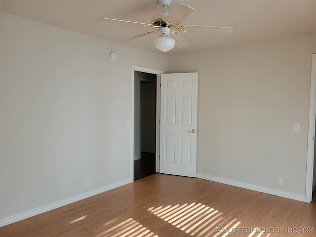 spare room featuring light hardwood / wood-style flooring and ceiling fan