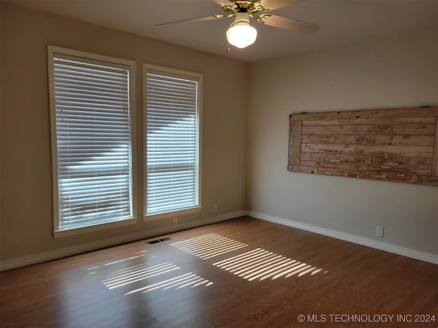 unfurnished room with ceiling fan and hardwood / wood-style flooring