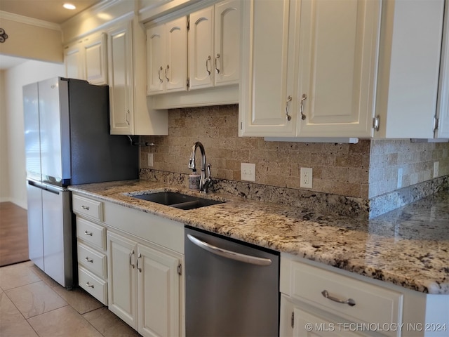 kitchen featuring white cabinetry, backsplash, stainless steel appliances, and sink