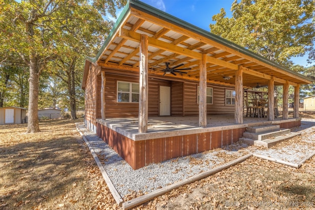 exterior space featuring a shed and ceiling fan