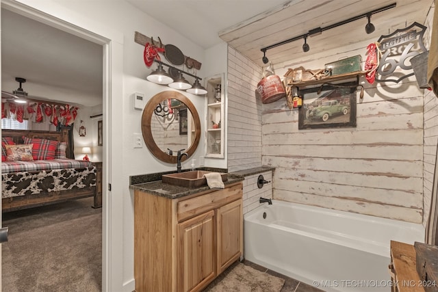 bathroom featuring vanity and a tub