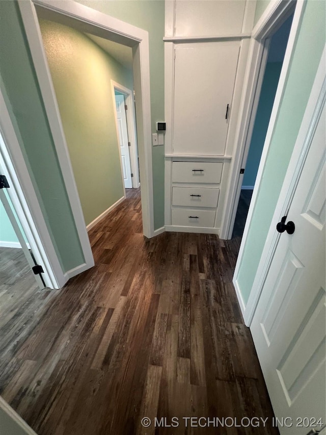 corridor with dark wood-type flooring