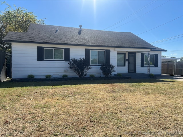 ranch-style home with a front lawn