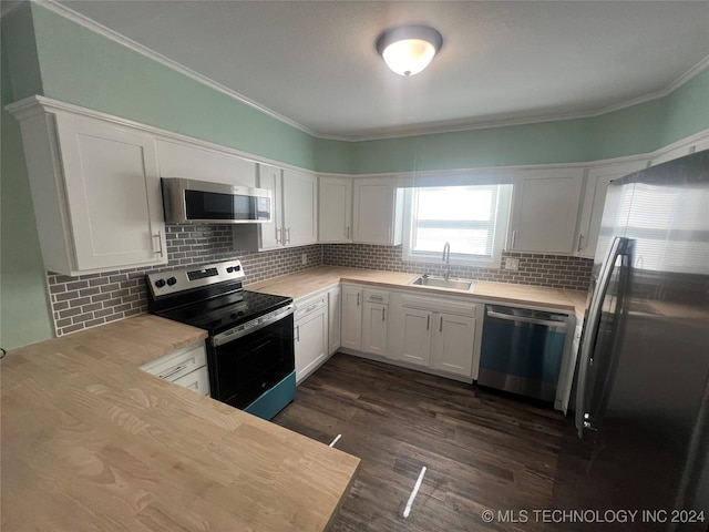 kitchen featuring white cabinetry, appliances with stainless steel finishes, sink, and decorative backsplash