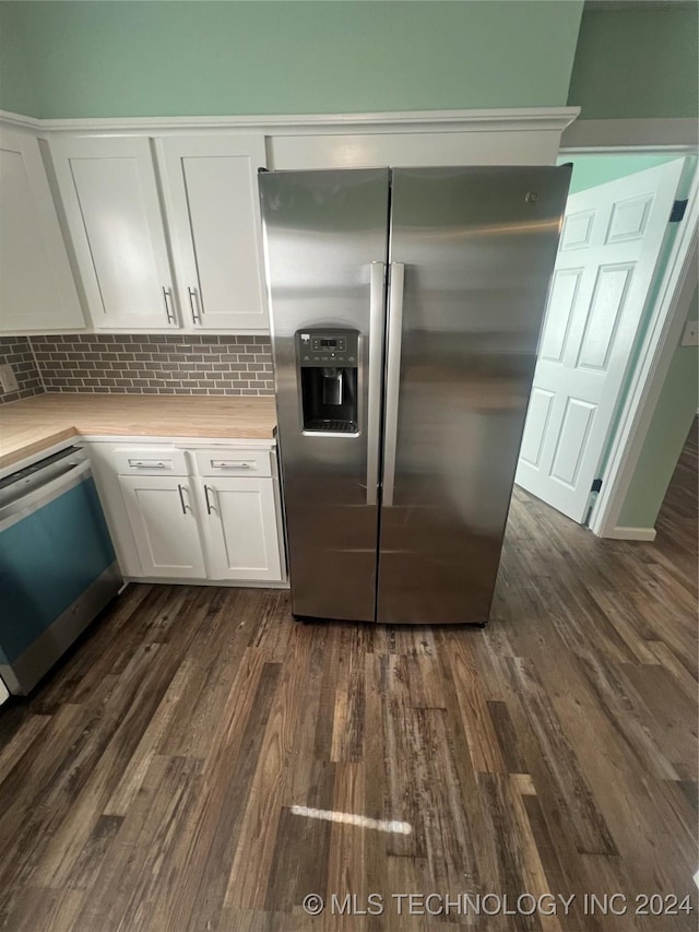 kitchen with dark wood-type flooring, stainless steel appliances, decorative backsplash, and white cabinets