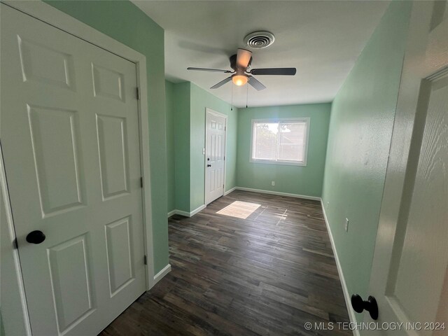 interior space featuring ceiling fan and dark hardwood / wood-style flooring