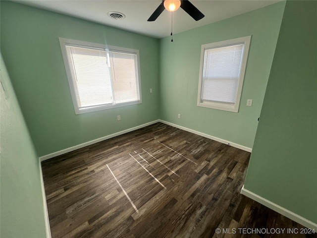 spare room with ceiling fan and dark hardwood / wood-style floors