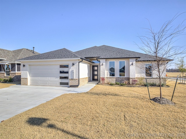 prairie-style home featuring a garage and a front yard