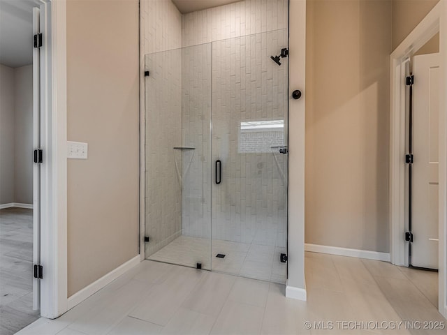 bathroom featuring tile patterned floors and a shower with door