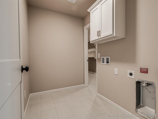 clothes washing area featuring electric dryer hookup, cabinets, and hookup for a washing machine