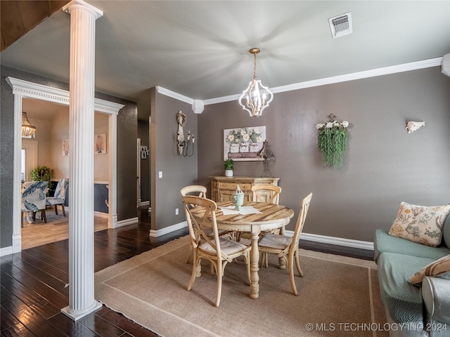 dining space featuring ornate columns, ornamental molding, and dark hardwood / wood-style floors