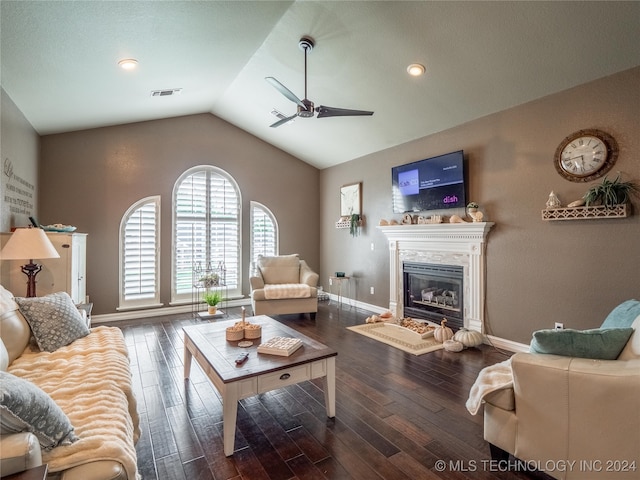 living room with lofted ceiling, hardwood / wood-style floors, a fireplace, and ceiling fan