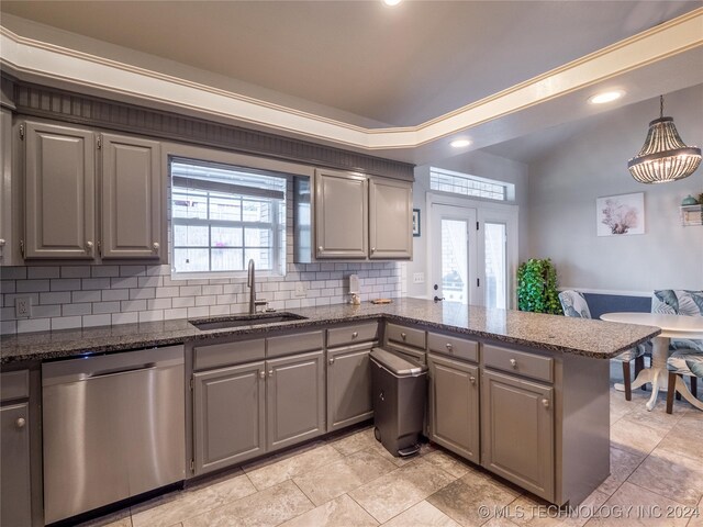 kitchen with sink, dishwasher, kitchen peninsula, and plenty of natural light